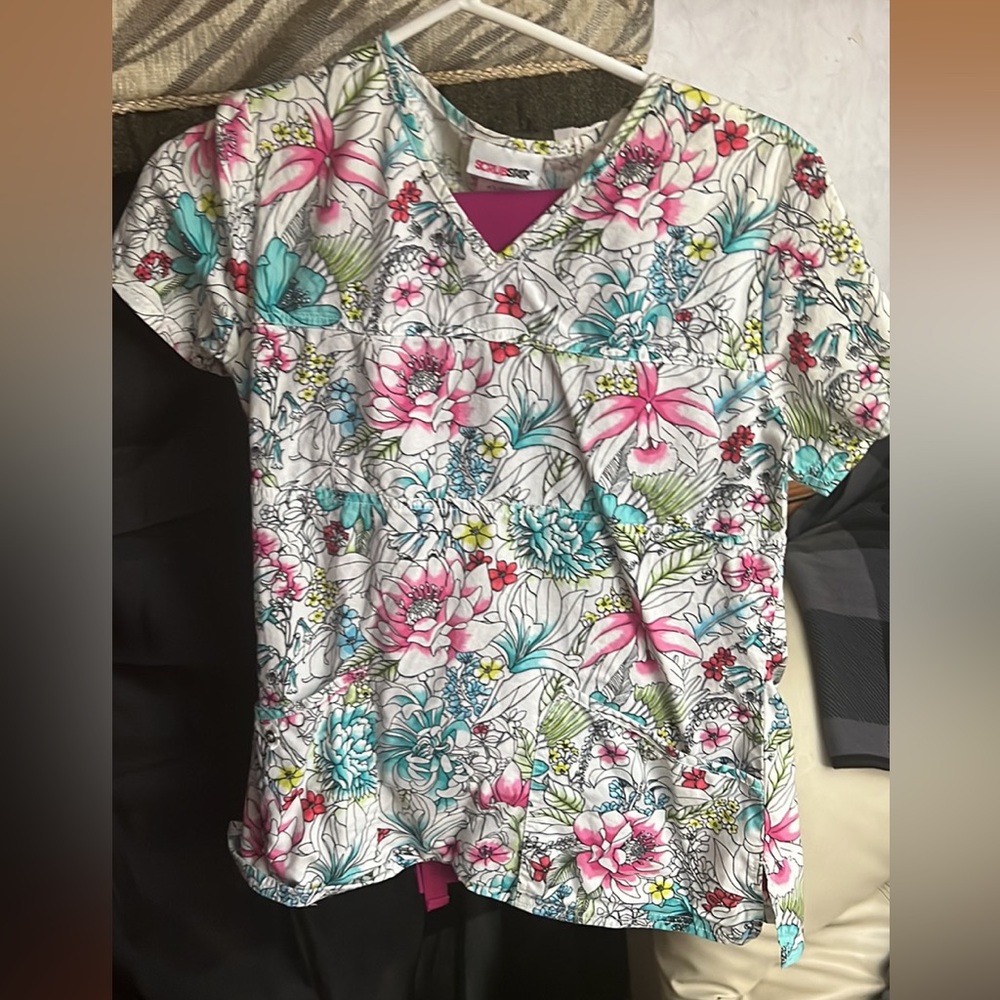 8 pairs of Women’s scrubs size small to a big medium tops and bottoms